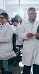 Chemical, group and woman in lab, glasses and happy with feedback from mentor, gloves and medical research. Healthcare, intern and mature scientist with investigation, biotechnology and tablet