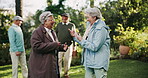 Elderly, woman and friends with laughing in park for funny joke, gossip story and happy in retirement. Senior, people or conversation in garden of nursing home with talking, bonding and relax outdoor