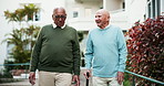 Nursing home, senior men and walk in garden for leisure, bonding and sharing past story in morning. Elderly friends, stroll and chat on pathway for memories, conversation and comfort in retirement