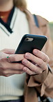 Woman, hands and typing with phone in city street for outdoor communication, social media or travel. Closeup of female person texting on mobile smartphone for online app or service in an urban town