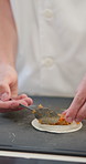 Hands, chef and person with pastry, food and prepare dough with skills, spoon and nutrition. Closeup, employee or student cook with ingredients, mini pie or practical exam for culinary school or meal