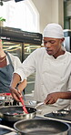 Man, chef and cooking class in kitchen with students, industry or hospitality for diet, nutrition or food. People culinary and gourmet cuisine for menu, professional or skill in preparation at school