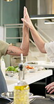 Hands, high five and cooking class in kitchen, industry or hospitality for diet, nutrition or food. People, culinary and gourmet cuisine for menu, celebration or progress for skill, support or school