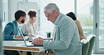 Mature businessman, thinking and typing with laptop for decision, communication or email in boardroom. Senior man, CEO or executive in wonder or thought on computer for business proposal at workplace