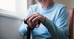 Balance, cane and hands with senior person in bedroom of retirement home to relax. Healthcare, support and walking stick with elderly resident in assisted living apartment for medical recovery