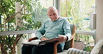 Home, relax and senior man with photo album, memory and retirement with nostalgia, grief and loss. Apartment, pensioner and mature guy with picture, gratitude and missing a loved one and photos