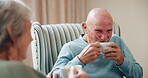 Coffee, conversation and smile with old couple in living room of retirement home to relax for wellness. Face, happy or love and man with oxygen talking to woman in apartment for bonding or break