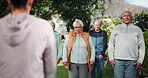 Group, senior and people for exercise outdoor with instructor, stretching training and mobility of health. Elderly, community and coach for fitness class, shoulder workout and wellness on retirement