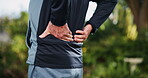 Senior man, exercise and hands with back pain in park for muscle cramp, inflammation and strain. Outdoor, fitness and body of person with workout injury for arthritis, tension and accident in nature