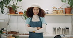 Cafe, waitress and woman with arms crossed, face and confidence with startup, store and apron. Portrait, person and employee with pride, small business and restaurant with friendly service and retail