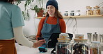 Woman customer, cashier and payment in cafe for coffee purchase, transaction or scanning mobile. Service, barista and person at restaurant for bill, pos machine or point of sale with smartphone