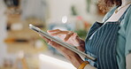 Hand, woman and scroll on tablet in cafe for online order management, inventory control and schedule delivery. Waitress, business owner and digital of e commerce stock, menu planning and food service