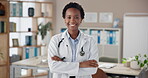Doctor, face and black woman in clinic with arms crossed for healthcare confidence and cardiology career. Medical, professional and portrait in hospital office for medicine, treatment and laughing