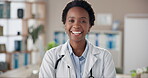 Happy doctor, face and black woman in clinic with confidence for healthcare and cardiology career. Medical, professional and portrait in hospital office for medicine, treatment or trust with laughing