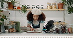 Woman, waiter and notebook for checklist at cafe in counter with stocktaking. Small business, female person and barista or cashier with laptop for ecommerce, online orders and schedule in coffee shop