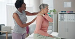 Senior, woman and physical therapy with massage for shoulder pain in clinic with healthcare or injury treatment. Physiotherapist, medical expert and old patient with recovery or rehabilitation on bed