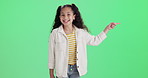 Pointing, happy and face of child on green screen for promotion, bargain and discount news. Excited, fashion and portrait of isolated young girl with hand gesture for announcement on chromakey