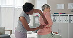 Senior, woman and physiotherapist with consultation for back pain in clinic with healthcare or injury treatment. Physical therapy, medical expert and old patient with checkup or rehabilitation on bed