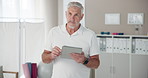 Tablet, physiotherapist and mature man in clinic with confidence for healthcare career. Research, digital technology and male chiropractor with online medical records for rehabilitation service.