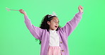 Girl, princess and happy for dancing by green screen with wand, cheers and games by background. Kid, smile and celebration with crown, comic and excited for fantasy with magic power by mockup space