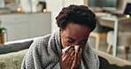 Black woman, sick and nose blow with tissue, blanket and wipe in house for virus, allergy and flu. African girl, cold and sneeze with paper for sinusitis, fever and cough for tuberculosis or health 