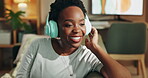 Black woman, relax and dancing with headphones on sofa for streaming music, listening audio and energy at house. Happy, female person and fun with headset for podcast, carefree and subscription