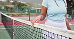 Net, woman and hand of tennis player on court walking and getting ready for sports match or practice. Fitness, outdoor and female athlete at stadium for badminton game, training or competition.