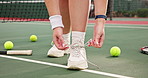 Person, hands and tying shoes with laces for game, match or sports on turf, court or outdoor pitch. Closeup of athlete or tennis player in preparation or getting ready for challenge or competition