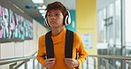 Music, child and school hallway with headphones, hip hop and audio ready for after hours tutoring. Young man, teen and gen z with dance and web song in study, education and academic learning campus