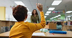 Hand, back and kid with question in library for education service, request and academic support. Student, studying and boy with gesture at school desk for librarian resource, query or asking for book