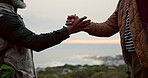 Handshake, hiking and hobby with friends outdoor in mountains for backpacking, exercise or fitness. Active, sports and wellness with people shaking hands in nature together for adventure or discovery