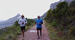 Men, nature and running on mountain for cardio, exercise and wellness in retirement with commitment. Elderly people, outdoor and workout with personal trainer for health, marathon or fitness training