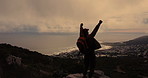 Arms raised, hiking and success with man on mountain peak for hobby, fitness or view of ocean. Achievement, celebration and goals with hiker on summit in nature for action, challenge or victory