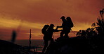 Climbing, help and hiking with silhouette of friends outdoor in mountains at sunset for fitness or hobby. Health, teamwork and wellness with hiker people in nature together for adventure or journey