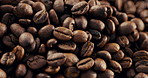 Organic, roasted and beans for coffee production with sustainable granules in studio. Natural, caffeine grains and explosion of fresh brown seeds for beverage of espresso, latte or cappuccino.