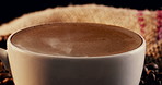 Coffee, aroma and cup with dark roast at cafe for strong caffeine, latte or cappuccino on table. Closeup of mug, brew or liquid with beans or brown froth for mocha, espresso or breakfast beverage