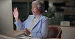 Mature woman, headset and wave as online english teacher on computer at night in office for language lesson. Female person, night and video call with teaching on virtual class for distance education