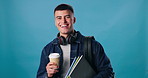 Coffee, books and face of man in studio for exchange student education with overseas travel. Smile, cappuccino and portrait of person with study material, headphones or backpack by blue background.