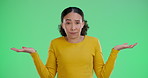 Shrug, doubt and face of woman by green screen for unsure, decision or choice for university. Education, confused and portrait of student from Brazil with dont know gesture for college by chroma key.