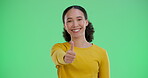 Girl, face and thumbs up on green screen in studio for positive vote or review, agreement and affirmation. Woman, portrait and hand gesture or yes sign for approval, well done and good reputation.