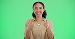 Girl, face and happy with thumbs up on green screen in studio for positive vote or review, agreement and affirmation. Woman, hand gesture and yes sign for approval, well done and good reputation.