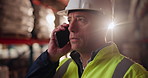 Businessman, helmet and contractor with phone call in logistics for stock control or quality assurance at warehouse. Young man or employee talking on mobile smartphone in supply chain for shipment