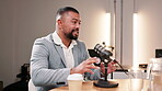 Business, man and microphone for interview on podcast or broadcast for youth empowerment and motivation. Guest, presenter and discussion in online talk show or live streaming for career advice