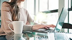 Laptop, coffee and hands of businesswoman typing in office for finance, profit or equity project. Computer, cappuccino and female financial analyst with research for online investment risk report.