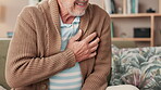 Senior, man and sofa with hands for chest pain in retirement home, heart attack signs and cardiac symptoms or angina. Elderly person, discomfort and shortness of breath for medical emergency on couch