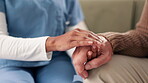 Nurse, man and senior care on couch with hands, healthcare and support or wellness in apartment together. Woman, lounge and trust or professional in retirement home, caregiver and comfort gesture