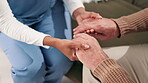 Nurse, man and elderly care with support with hands, healthcare and compassion or wellness in apartment. Woman, lounge and trust or professional in retirement home, caregiver and comfort gesture
