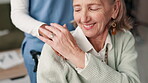 Senior woman, caregiver and holding hands for support at retirement home, healthcare and wellness of medical help. Nurse, patient and empathy with trust, comfort and care for recovery service advice
