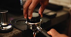 Machine, hands and barista with coffee tamper for preparing latte, espresso or cappuccino in cafe. Morning, service and closeup of person with equipment for warm caffeine beverage in restaurant.