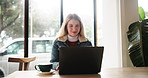 Laptop, coffee and woman in cafe for remote work on creative project with editing for multimedia. Typing, computer and female journalist with freelance career for online news reporting in restaurant.